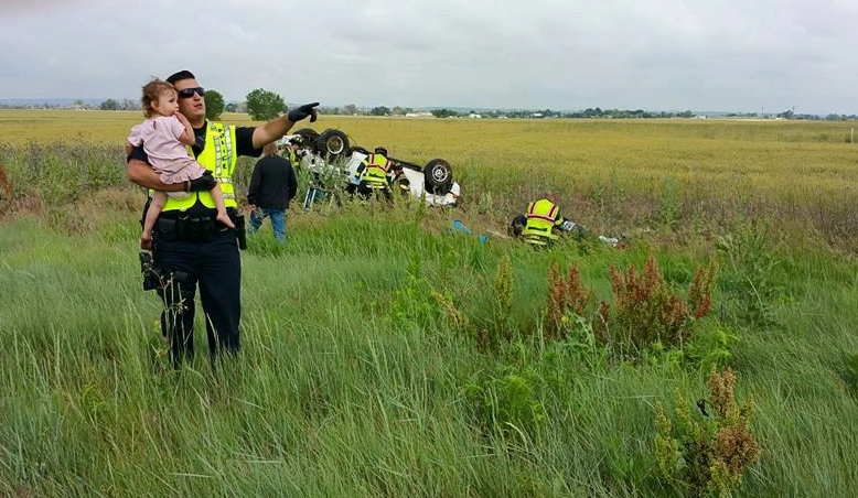 Officer Nick Struck comforts a toddler after a tragic accident in Brighton, Colorado